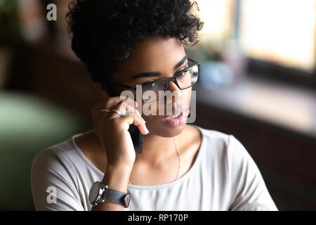 Close up portrait attractive serious young woman talking on phone Stock Photo