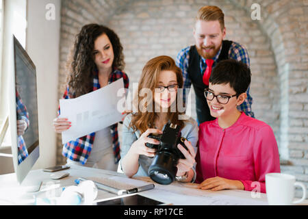 Picture of young attractive designers looking at camera Stock Photo