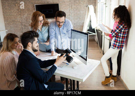 Picture of young attractive designers looking at camera Stock Photo