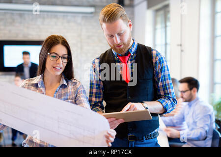Business people and architects collaborating on project Stock Photo