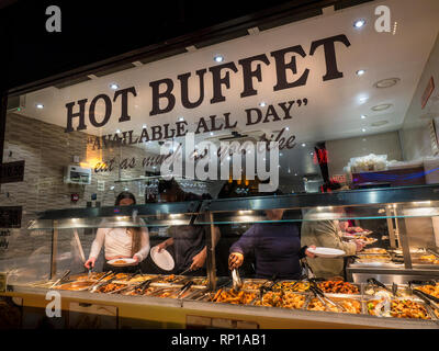 Chinese hot buffet selection 'eat as much as you like' window with patrons selecting a variety of Chinese food Wardour Street Chinatown Soho London UK Stock Photo