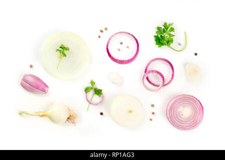 Red and white onions, shallots, parsley leaves and peppercorns, shot from the top on a white background Stock Photo