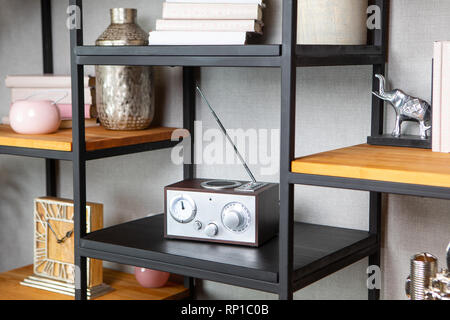 Compact radio on the shelf in the vintage interior of the living room Stock Photo