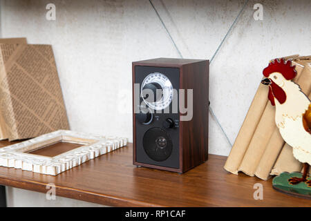 Compact radio on the shelf in the vintage interior of the living room Stock Photo
