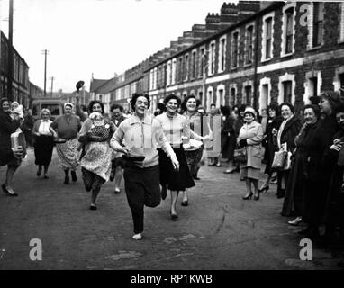 Pancake Day in Cardiff  A pancake race organised by the St Agnes Women Fellowship in aid of Congo Relief was held at Bertram Road, Roath, Cardiff.  Picture shows the finish of the over 40's race. 15th February 1961.