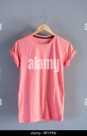 Retro fold Pink cotton T-Shirt clothes colorful mock up template on grunge white wood background concept for retail dress shop backdrop, Blank flat la Stock Photo