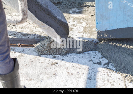 Workers pour the Foundation for the construction of a residential building using mobile concrete mixers Stock Photo