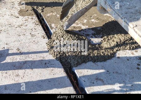 Workers pour the Foundation for the construction of a residential building using mobile concrete mixers Stock Photo