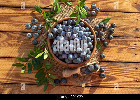 Blueberries On Old Wooden Planks Top View. Outdoor Image Shot In The Sunshine Stock Photo