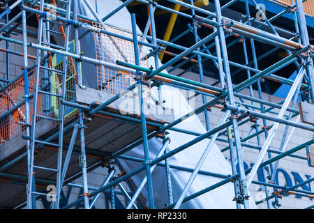 The steel scaffold is set up on a renovated building. Construction site with steel scaffolds Stock Photo