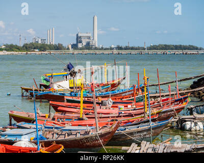 Small fishing port at Map Ta Phut, Rayong Province in Thailand. In the background, the power station at the growing industrial estate in Map Ta Phut. Stock Photo