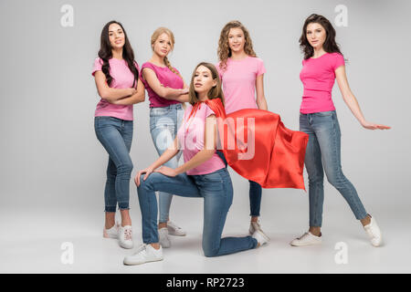 People wearing grey t-shirts near white brick wall. Mockup for design ...