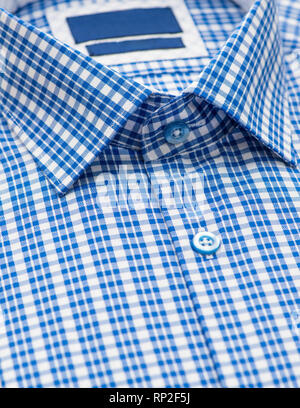 blue shirt with checkered pattern and with a focus on the collar and button, close-up Stock Photo
