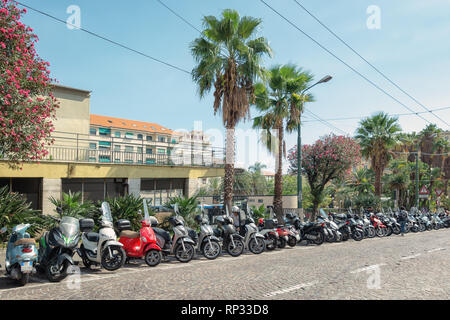 San Remo, Italy, September 18, 2018:  Motorcycles, scooters and mopeds parked on the via Bartolomeo Asquasciati in the center of the Italian town San  Stock Photo