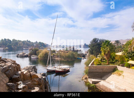 Felucca boats moored near island on River Nile, near Aswan, Egypt Stock Photo