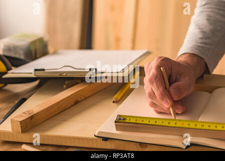 Carpenter making wooden picture frame in small business woodwork workshop, close up of hands Stock Photo