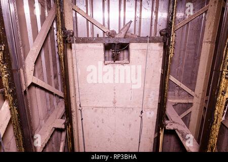 Old elevator shaft with counterweight. Lift reconstruction. Industrial ...