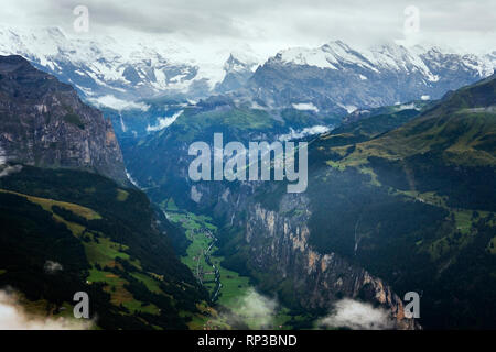 View from the Männlichen down into the spectacular Lauterbrunnen valley with the Lauterbrunnen Wall blocking the head of the valley: Switzerland Stock Photo