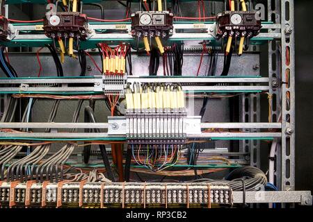 Contactors and safety relays for emergency stop monitoring in control cubicle. Stock Photo