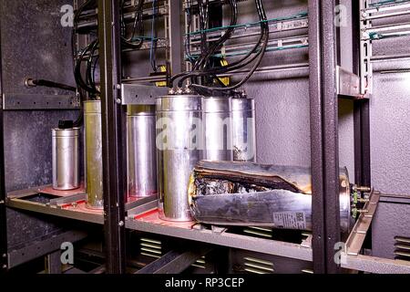 Industry electrical condensers. Broken industry electrical condenser Stock Photo