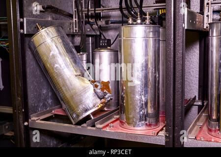 Industry electrical condensers. Broken industry electrical condenser.  Stock Photo