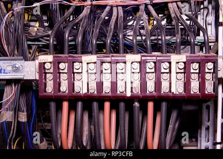 Old brown terminal blocks. Multi colored wires.  Closeup Stock Photo