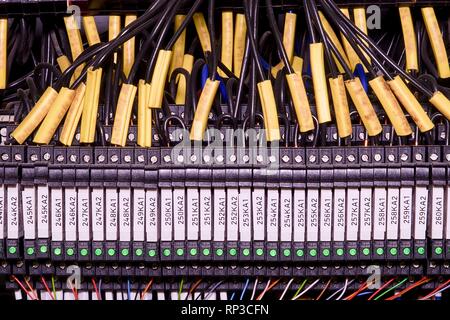 Modern terminal blocks with multi colored wires. Black wires with caption fields Stock Photo