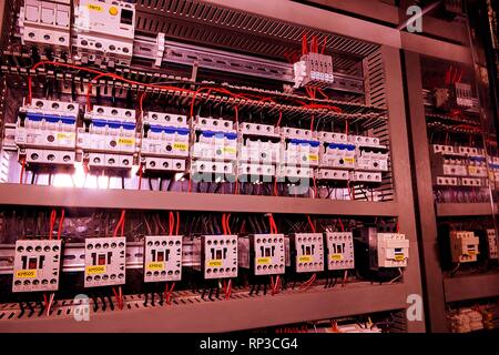 Image shows circuit breakers and electrical contactors. Close-up. Modern distribution case. Contorl cubicle. Add brown filter Stock Photo