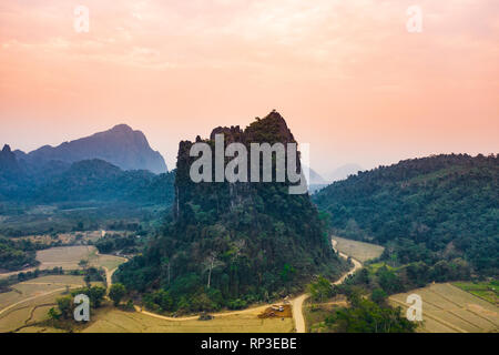 (View from above) Stunning aerial view of a beautiful limestone mountain at sunset in Vang Vieng, Laos. Stock Photo