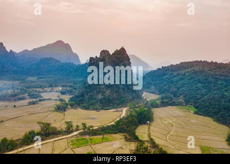 (View from above) Stunning aerial view of a beautiful limestone mountain at sunset in Vang Vieng, Laos. Stock Photo