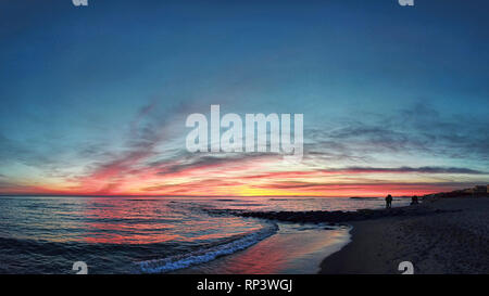 Awesome golden hour sunset at the beach with wonderful pastel colored sky Stock Photo