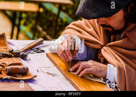 Valencia, Spain - January 27, 2019: Artisans disguised in medieval times showing old crafts in an exhibition of a festival. Stock Photo