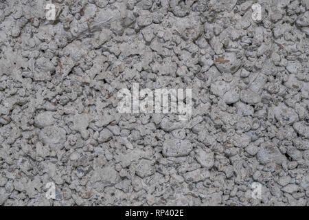 The texture of the old wall on a building made of cement mixed with stones Stock Photo