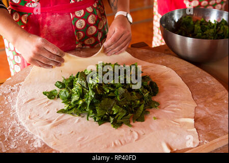 Woman making Spanakopita, Greek spinach pie, the Peloponnese, Greece Stock Photo