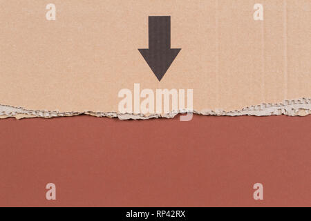 Brown corrugated cardboard ragged edge with black arrow on brown background Stock Photo