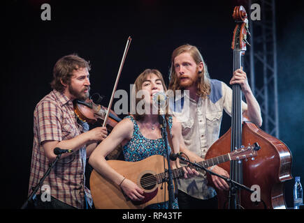 The American folk band The Stray Birds performs a live concert at the Danish folk, blues and country music festival Tønder Festival 2014. The band consists of the singers and musciains Maya de Vitry, Oliver Craven and Charlie Muench. Denmark, 28/08 2014. EXCLUDING DENMARK. Stock Photo