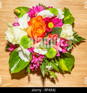 Gorgeous Colorful bouquet with roses and Lisianthus flowers top view on the wooden table. Floral arrangement. Beauty, fresh. Stock Photo