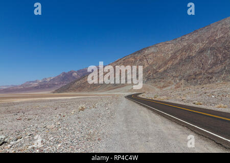 View north along Badwater Road towards Badwater Basin (round the bend), Death Valley National Park, California, United States. Stock Photo