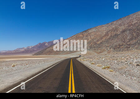 View north along Badwater Road towards Badwater Basin (round the bend), Death Valley National Park, California, United States. Stock Photo