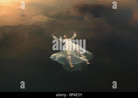 Beautiful floating dead woman in water . Ophelia conceptual Stock Photo ...