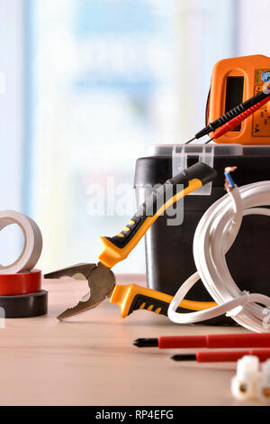 Exhibition of electrical material on wood table with window background. Vertical composition. Front view. Stock Photo