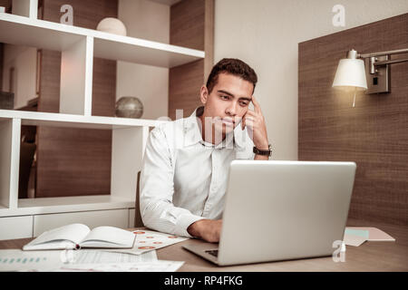 Businessman feeling overloaded working on month report Stock Photo
