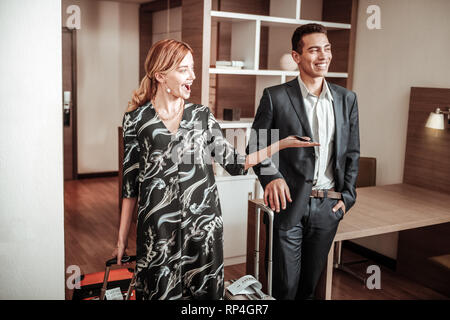 Blonde-haired wife feeling satisfied seeing nice luxury room Stock Photo