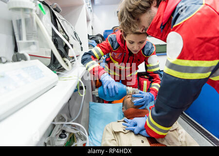 Paramedics in latex gloves doing cardiopulmonary resuscitation Stock Photo