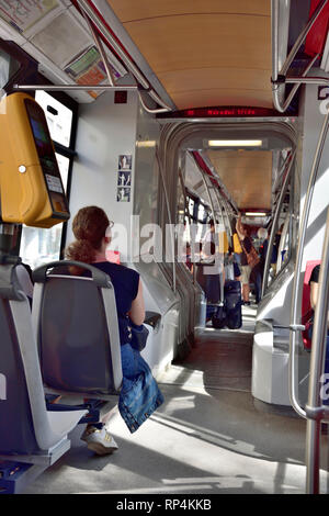 Passengers on Prague metro train seating inside carriage, Czech transport Stock Photo