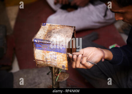 Craftsmen polishes precious stone in a small factory. Stock Photo