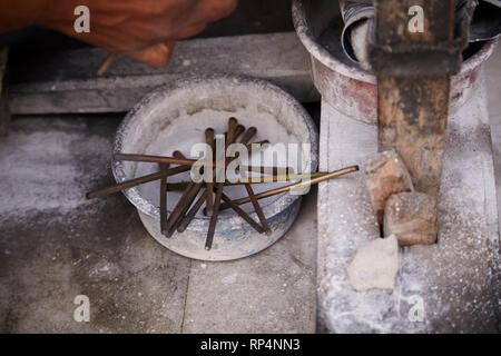 Craftsmen polishes precious stone in a small factory. Stock Photo