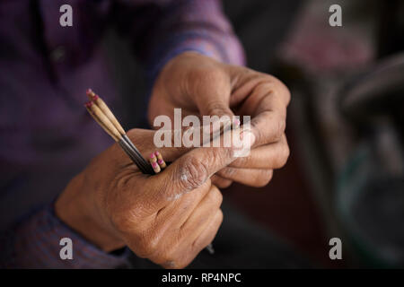 Craftsmen polishes precious stone in a small factory. Stock Photo