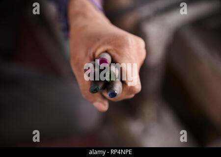 Craftsmen polishes precious stone in a small factory. Stock Photo