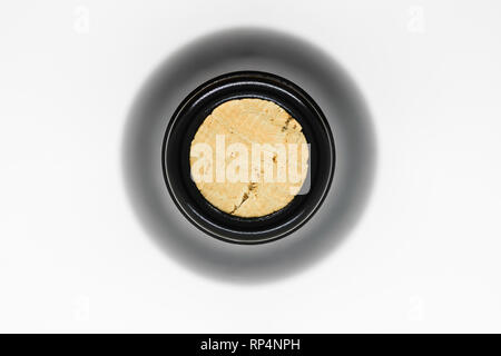 Closed with cork black glass wine bottle view from top on white background Stock Photo
